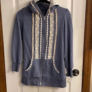 Blue hoodie with crochet detail.